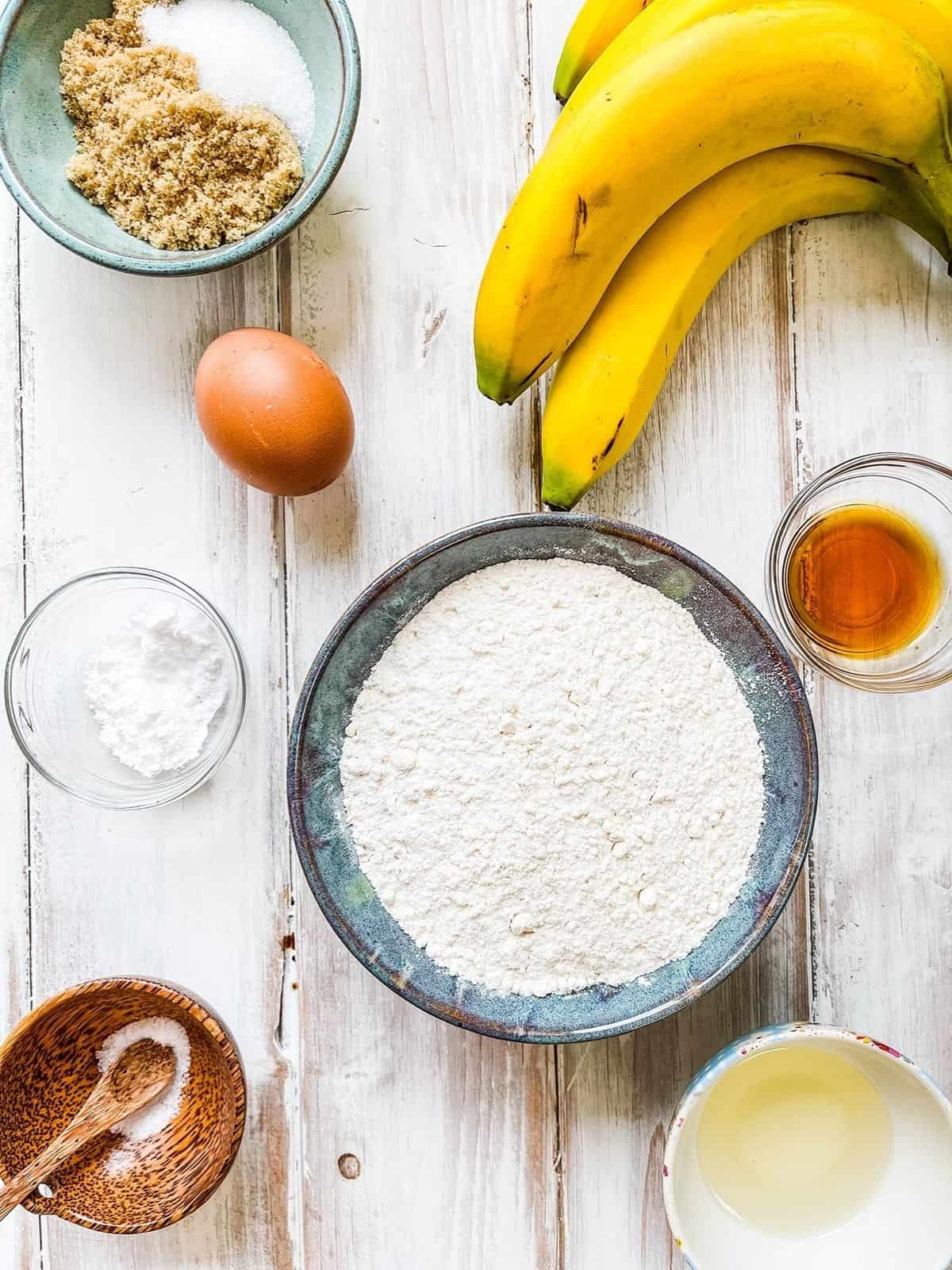 Ingredients needed to make low calorie banana bread on a white table.