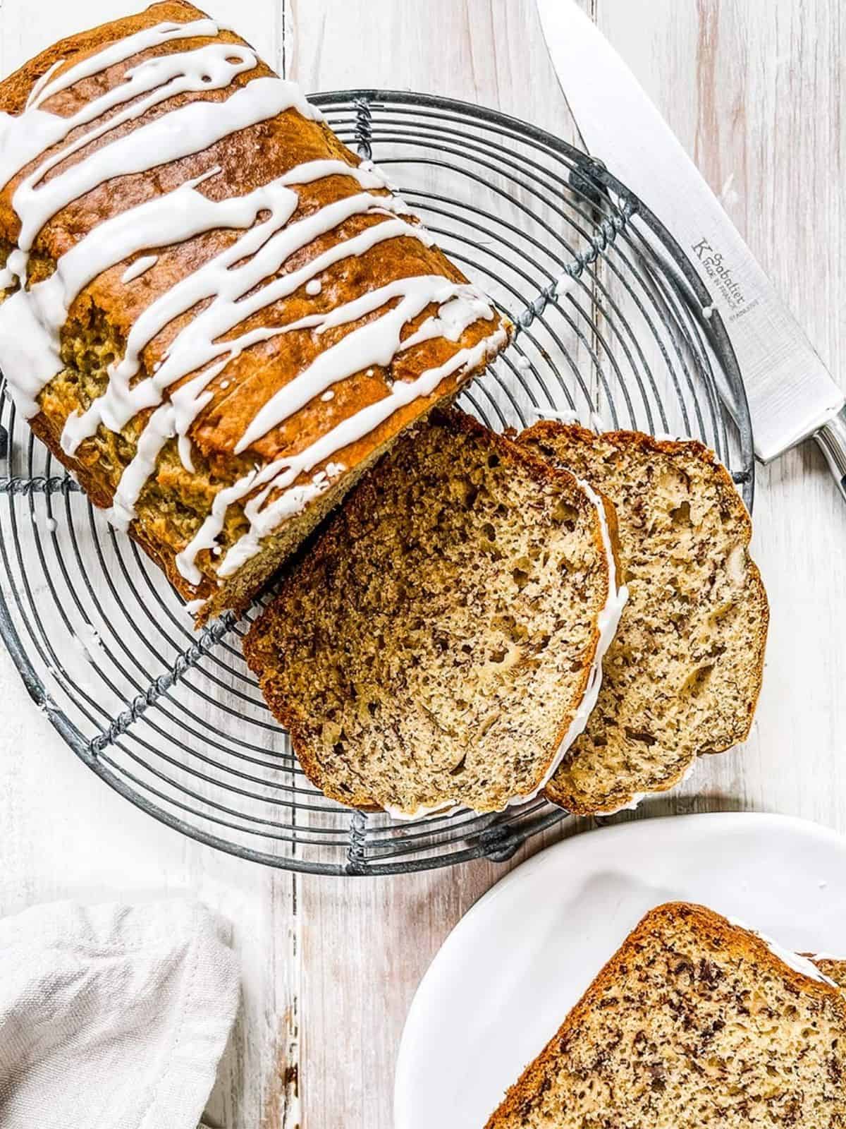 Sliced banana bread on a white table.