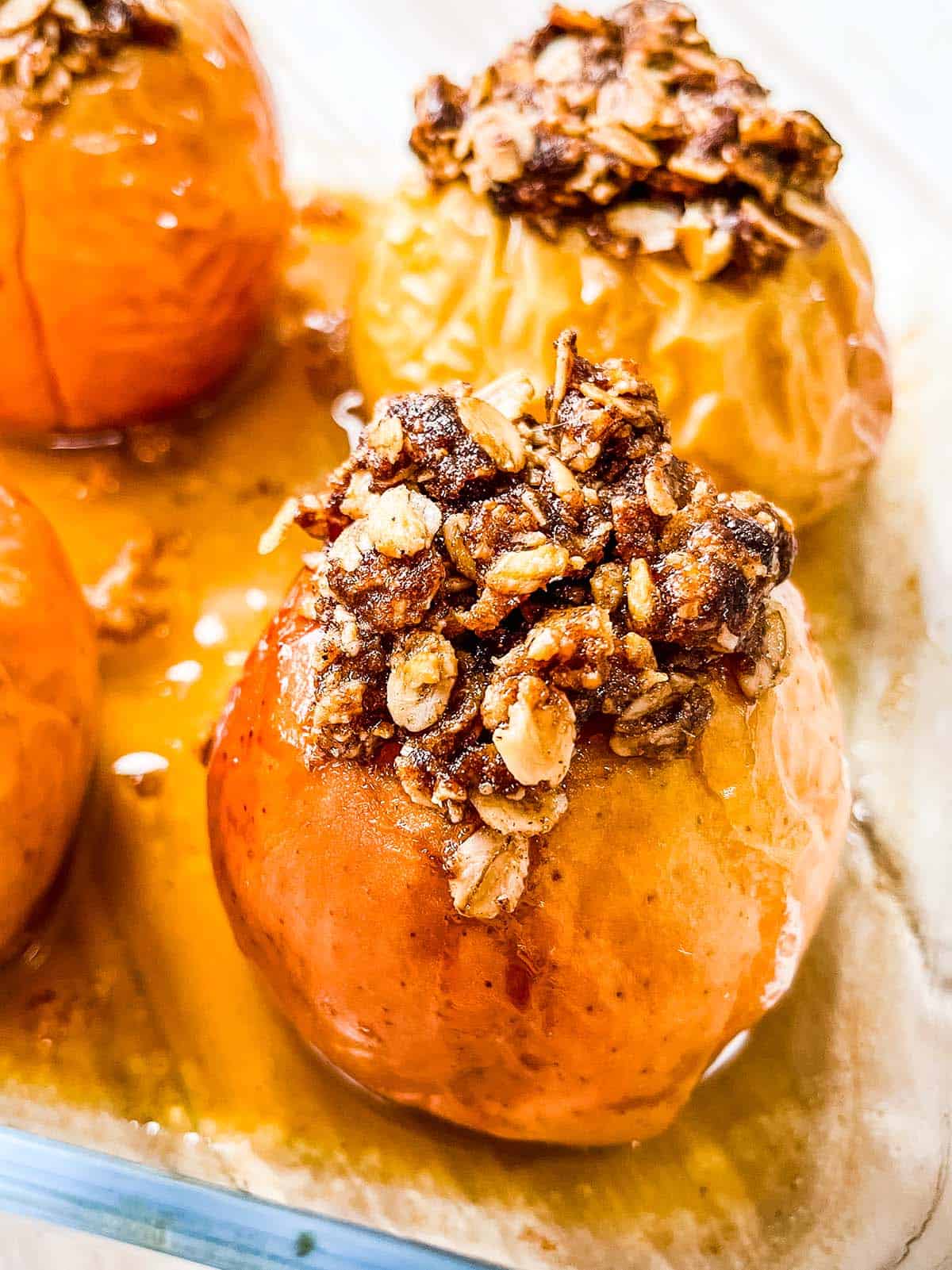 Baked apples in a glass dish.