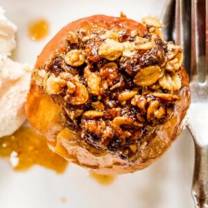 A top down picture of a baked apple topped with oats.