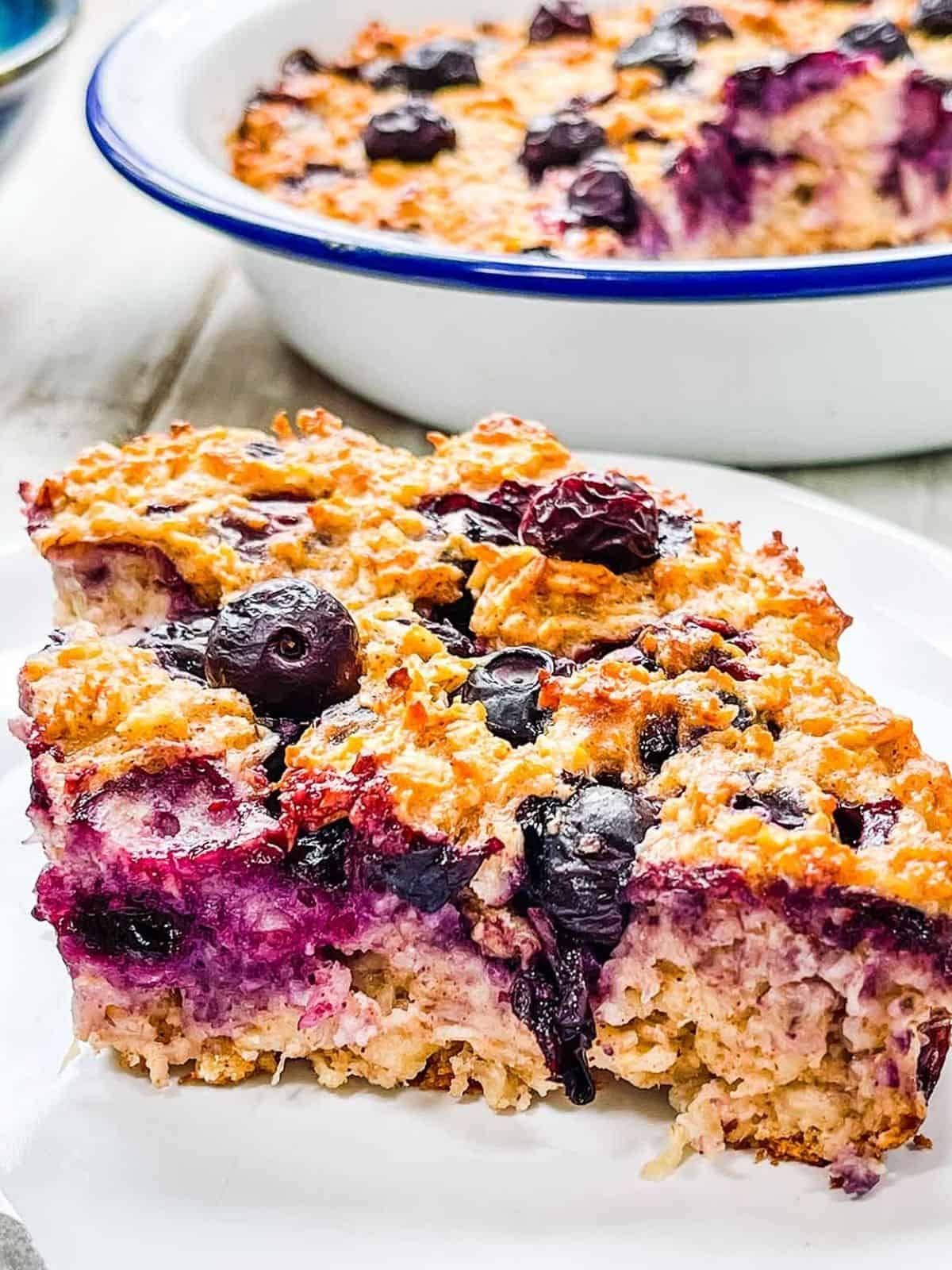 A slice of baked oatmeal with blueberries.